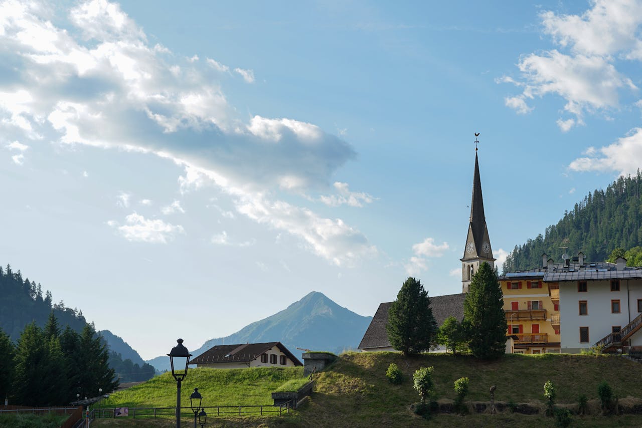 picturesque-alpine-village-with-church-spire-32608457